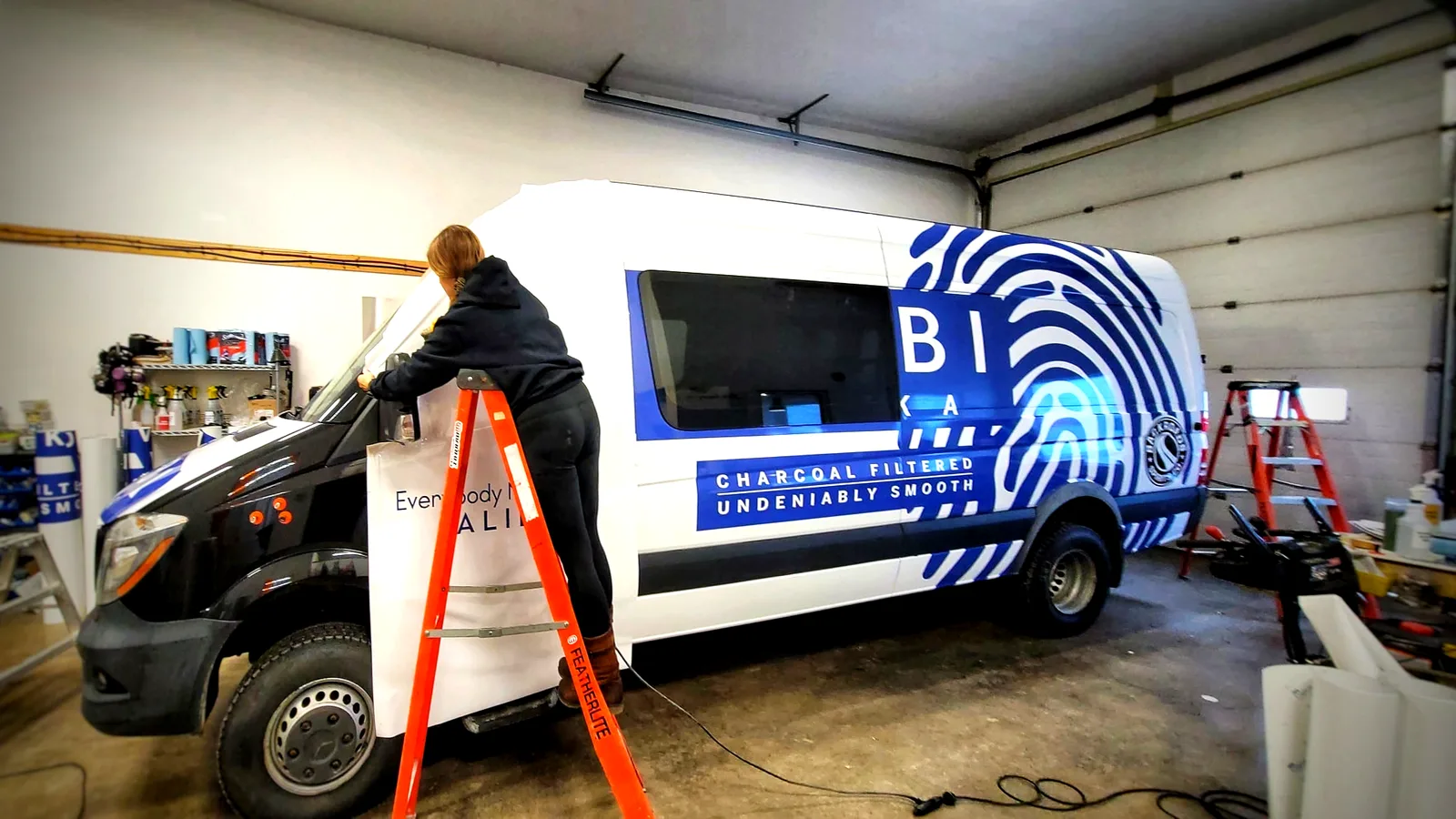 Amanda installing a vehicle wrap