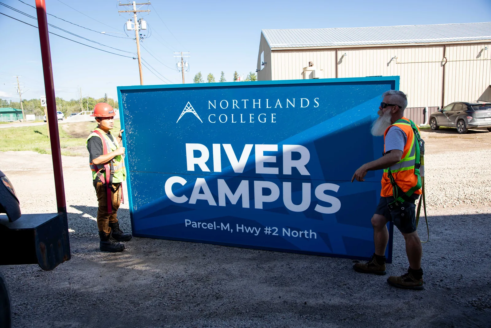 MarkIt crew installing the Northlands College River Campus sign
