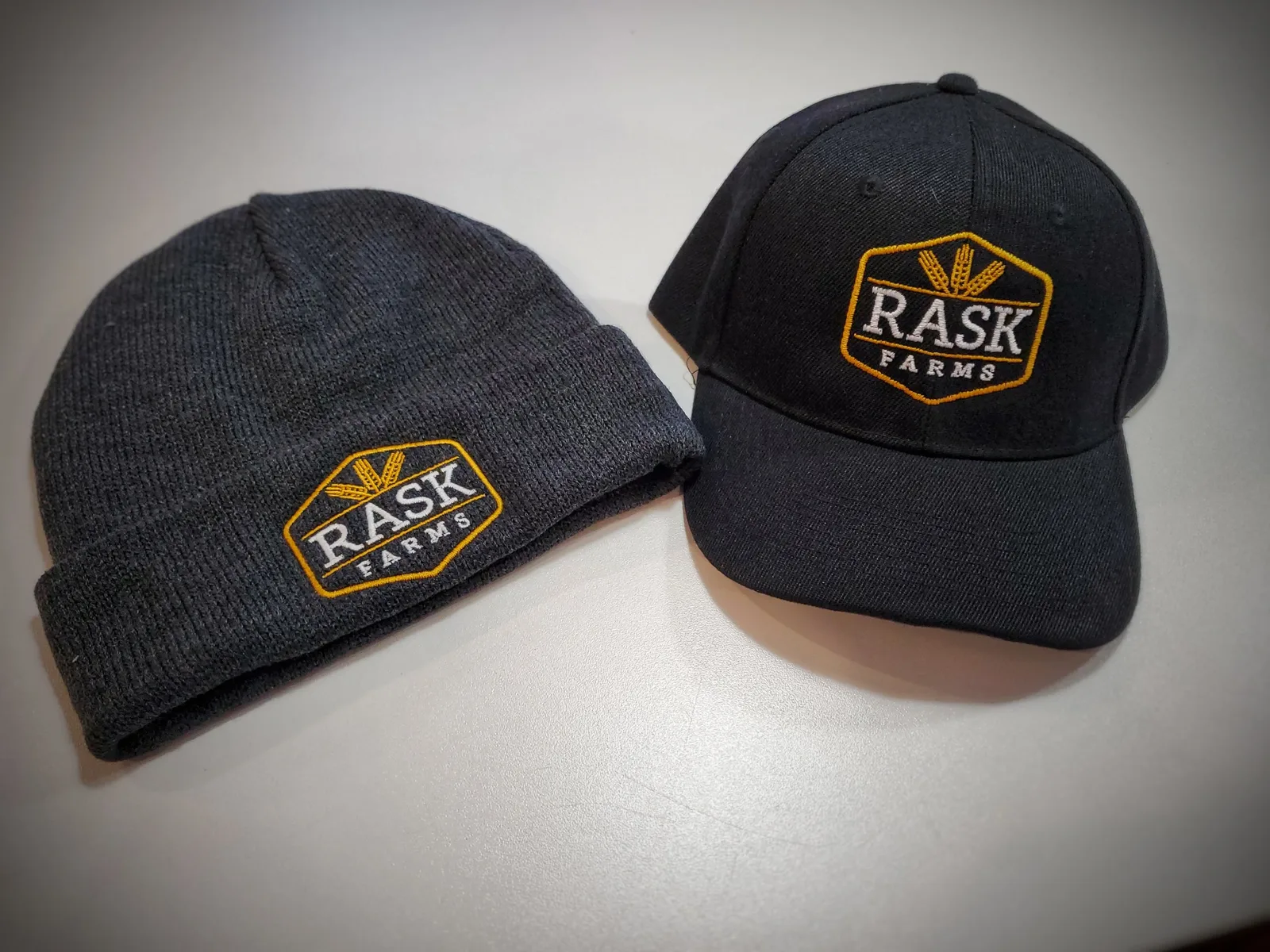 Rask Farms branded hats
