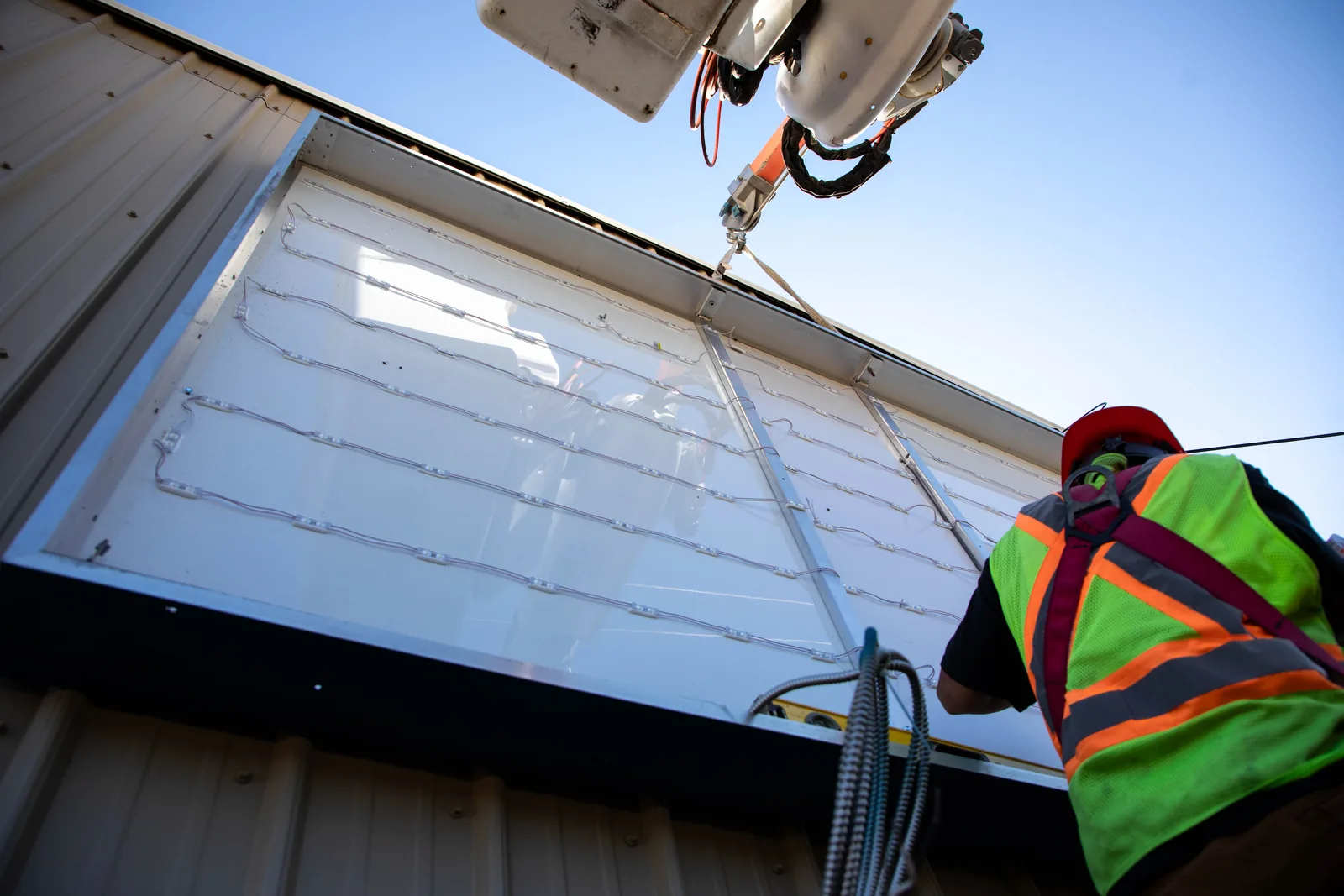 MarkIt crew installing an LED sign cabinet at Northlands College