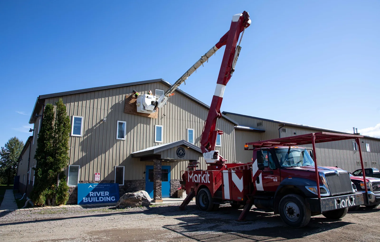 MarkIt bucket truck installing signage at Northlands College River Campus